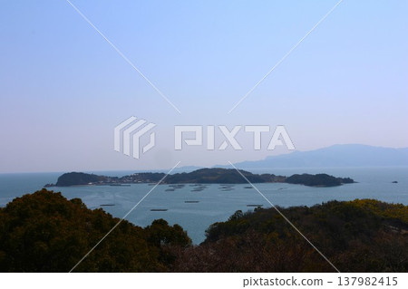 Otafu Island floating in the Seto Inland Sea under a clear blue sky. Otafu Island floating in the Seto Inland Sea under a clear blue sky. 137982415