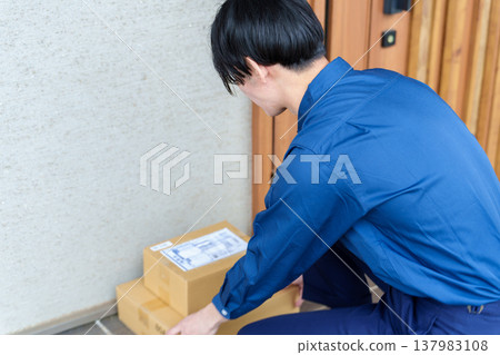 送貨司機將包裹放在前門。 137983108