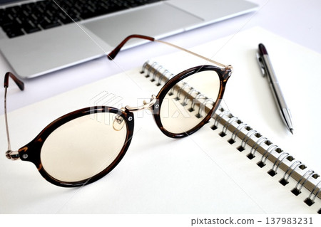 Writing utensils and glasses Writing utensils and glasses 137983231