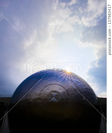 The silver dome of the Fukui Prefectural Dinosaur Museum, shining in the backlight, against a dramatic sky. The silver dome of the Fukui Prefectural Dinosaur Museum, shining in the backlight, against a dramatic sky. 137983417