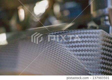 Close-up of the texture and pattern of carbon-fiber-look parts on a motorcycle. 137983501
