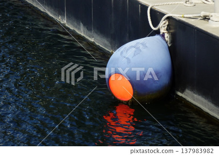 Blue mooring buoys at Yokosuka Port quay Blue mooring buoys at Yokosuka Port quay 137983982