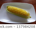 Boiled corn served on a white square plate 137984208