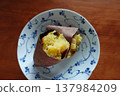 Roasted sweet potato served on a small plate 137984209