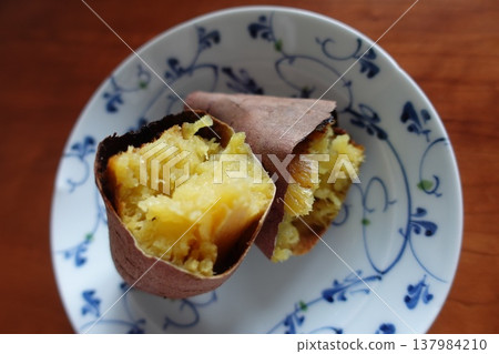 Close-up of a baked sweet potato served on a small plate Close-up of a baked sweet potato served on a small plate 137984210