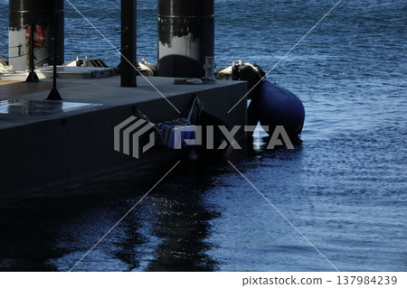 A quay where ships dock in a port 137984239