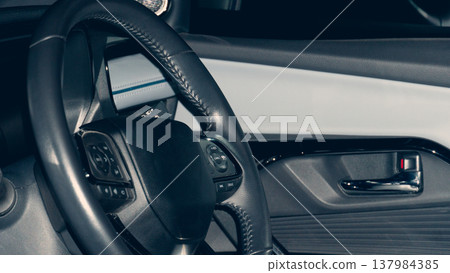 Interior features a multi-function steering wheel and a dark. Aggressive color scheme. Atmosphere is vintage at night. Interior features a multi-function steering wheel and a dark. Aggressive color scheme. Atmosphere is vintage at night. 137984385