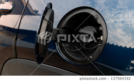 Close up shot of a car fuel filler neck with the gas cap removed. showing the circular opening for refueling. Designed for safe and efficient gasoline or diesel replenishment. 137984392