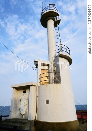 A white lighthouse (Hato Cape Lighthouse) stands tall against the blue sky. 137984403
