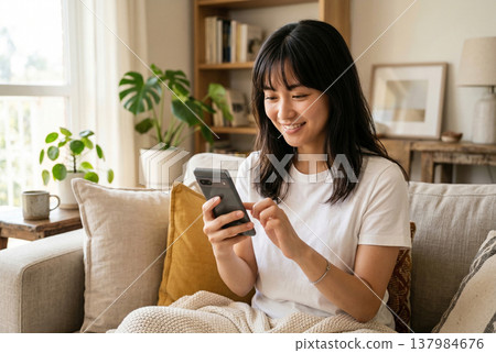 A woman using a smartphone in the living room Generative AI 137984676