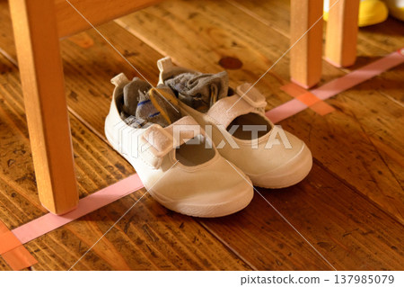 Children's daily lives as seen in their shoes and socks inside a nursery school Children's daily lives as seen in their shoes and socks inside a nursery school 137985079