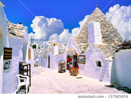 The beautiful houses of Alberobello with their pointed roofs The beautiful houses of Alberobello with their pointed roofs 137985659