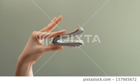 Hand holding bundle banknotes shaped like speaking mouth. Money talks, financial power Hand holding bundle banknotes shaped like speaking mouth. Money talks, financial power 137985672