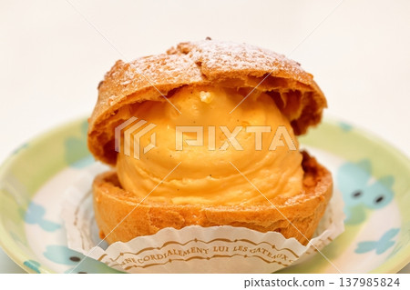 A cream puff filled with lots of custard cream. A cream puff filled with lots of custard cream. 137985824