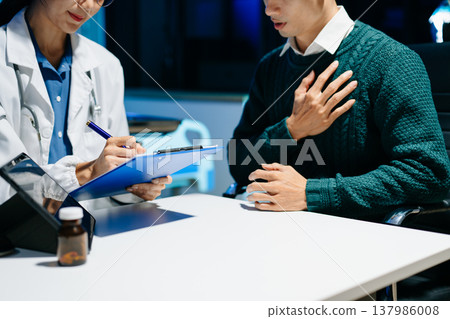 Doctor explains medical form as patient signs consent in modern clinic. Healthcare, insurance, medical consultation, diagnosis, treatment, documentation concept. 137986008