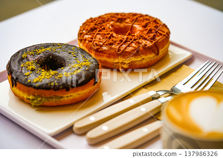 Cup of coffee decorated with a heart and dubai donuts 137986326