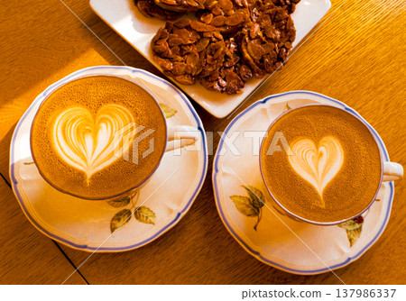 Cups of coffee decorated with a heart Cups of coffee decorated with a heart 137986337