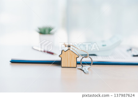 Home buying and mortgage planning concept for real estate investment and insurance, featuring a miniature house, keys, calculator, pen and contract on a bright desk in a modern office. real estate Home buying and mortgage planning concept for real estate investment and insurance, featuring a miniature house, keys, calculator, pen and contract on a bright desk in a modern office. real estate 137987624
