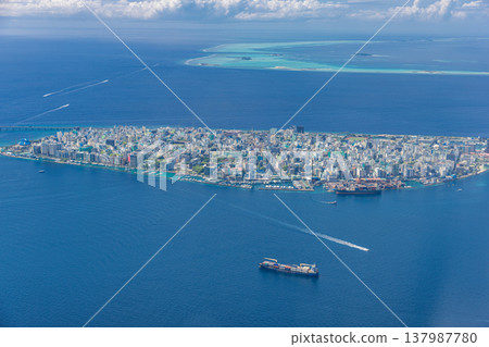 Drone aerial view of Male Maldives, turquoise ocean bay with boats, iconic capital city skyline, famous tropical destination, scenic luxury travel landscape 137987780