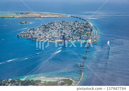 Aerial view of Male Maldives cityscape with turquoise ocean, boats, and iconic landmarks, famous tropical destination, scenic luxury travel background 137987784