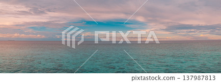 Majestic tropical ocean sunrise panorama radiant golden and pink sky, ethereal clouds reflected on calm turquoise water, serene inspirational nature landscape, dreamy idyllic summer banner wallpaper Majestic tropical ocean sunrise panorama radiant golden and pink sky, ethereal clouds reflected on calm turquoise water, serene inspirational nature landscape, dreamy idyllic summer banner wallpaper 137987813