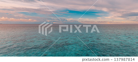 Radiant tropical ocean morning sunrise, colorful clouds over calm turquoise water, serene inspirational nature landscape, dreamy summer coastal banner background 137987814