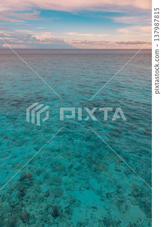 Vibrant tropical ocean sunrise panorama, glowing sky with fluffy clouds, peaceful calm water reflections, dreamy inspirational nature scene, serene summer wallpaper 137987815