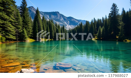Pristine alpine lake with emerald green water and pine forest reflection Pristine alpine lake with emerald green water and pine forest reflection 137988027