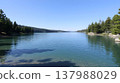 Pristine alpine lake with emerald green water and pine forest reflection 137988029