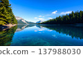 Pristine alpine lake with emerald green water and pine forest reflection 137988030