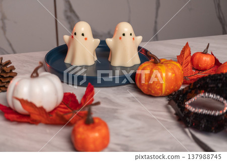 Halloween table decoration with white jelly ghosts, pumpkins and autumn leaves Halloween table decoration with white jelly ghosts, pumpkins and autumn leaves 137988745
