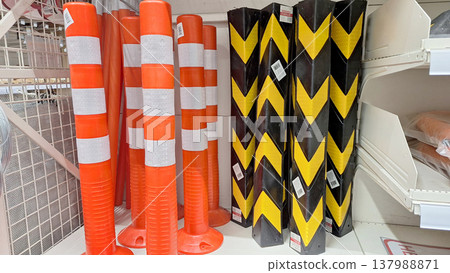 Colorful Traffic Cones and Warning Barriers Displayed Inside a Retail Storage Area Colorful Traffic Cones and Warning Barriers Displayed Inside a Retail Storage Area 137988871