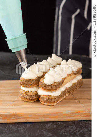 Dessert Tiramisu cake on a tray on a dark background 137989596
