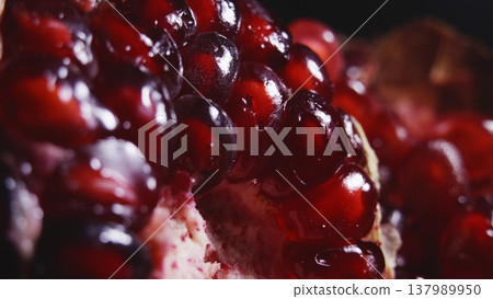 A juicy red pomegranate in the rays of light 137989950