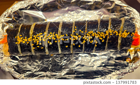 Korean kimpab rolls with vegetables, Korean kimpab on the foil Korean kimpab rolls with vegetables, Korean kimpab on the foil 137991783