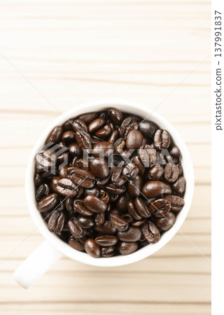 White cup of coffee beans 137991837