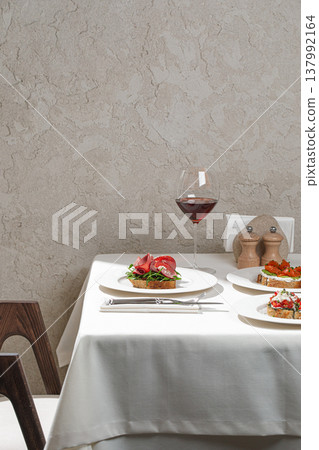 Assorted gourmet bruschetta with wine on table Assorted gourmet bruschetta with wine on table 137992164