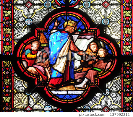Saint Louis attending the plague victims, stained glass window in the Basilica of Saint Clotilde in Paris, France 137992211