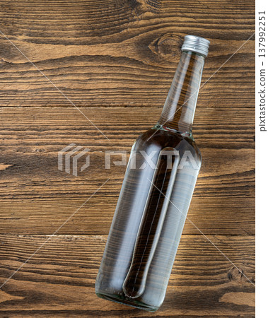 Vodka bottle on rustic wooden table Vodka bottle on rustic wooden table 137992251