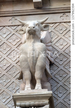 The winged ox symbol of St. Luke the Evangelist, statue on the facade of Saint Augustine church in Paris, France The winged ox symbol of St. Luke the Evangelist, statue on the facade of Saint Augustine church in Paris, France 137992394