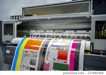 Large offset printing press or magazine running a long roll off paper in production line of industrial printer machine. Large offset printing press or magazine running a long roll off paper in production line of industrial printer machine. 137992489