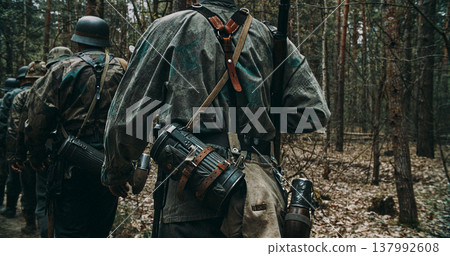 Close up of Wehrmacht soldier back with camouflage smock and combat gear Close up of Wehrmacht soldier back with camouflage smock and combat gear 137992608