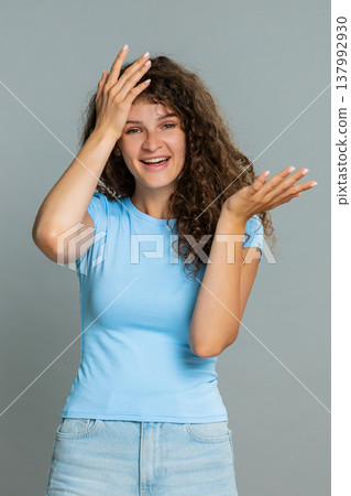 Woman making facepalm gesture laughing humorous reaction embarrassed funny silly mistake moment Woman making facepalm gesture laughing humorous reaction embarrassed funny silly mistake moment 137992930