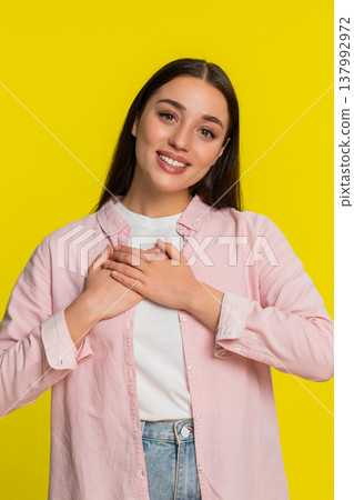 Young woman girl holding hands on chest expressing deep gratitude thankful emotional reaction 137992972