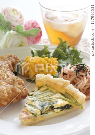 A one-plate meal of fried chicken and quiche. A one-plate meal of fried chicken and quiche. 137993531