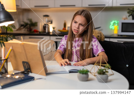Teenager girl frustrated homework puts notebook aside task from book sighs upset look down serious 137994147