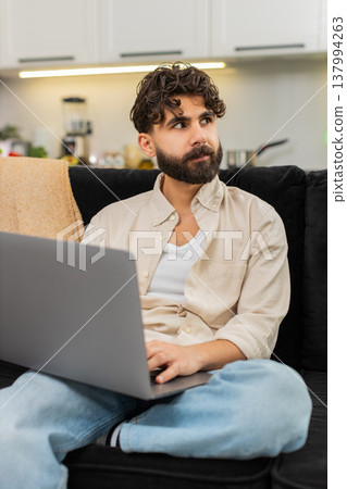 Indian man freelance worker with laptop typing focused remote job online planning ideas project work Indian man freelance worker with laptop typing focused remote job online planning ideas project work 137994263