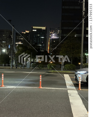 Tokyo Tower, spotted through a gap between buildings, from in front of the Imperial Palace Outer Garden. Tokyo Tower, spotted through a gap between buildings, from in front of the Imperial Palace Outer Garden. 137995353