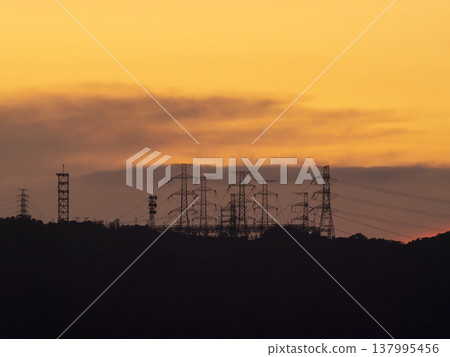 The dawn sky and the power transmission towers of the substation The dawn sky and the power transmission towers of the substation 137995456