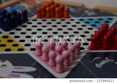 Chinese Checkers Game Board with Colorful Pegs 137995611